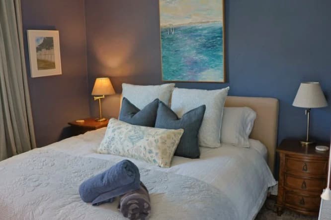 A second bedroom at The Homestead in soft blue tones