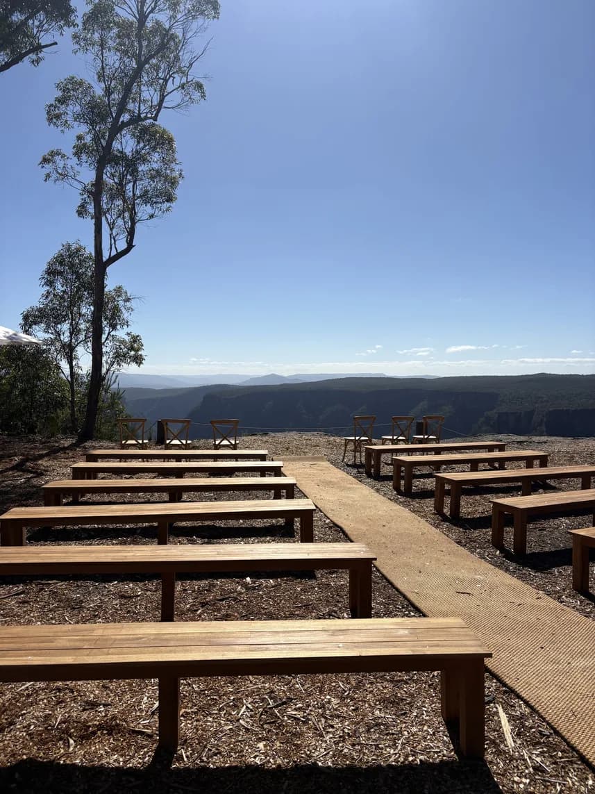 Rows of timber ceremony benches facing the escarpment