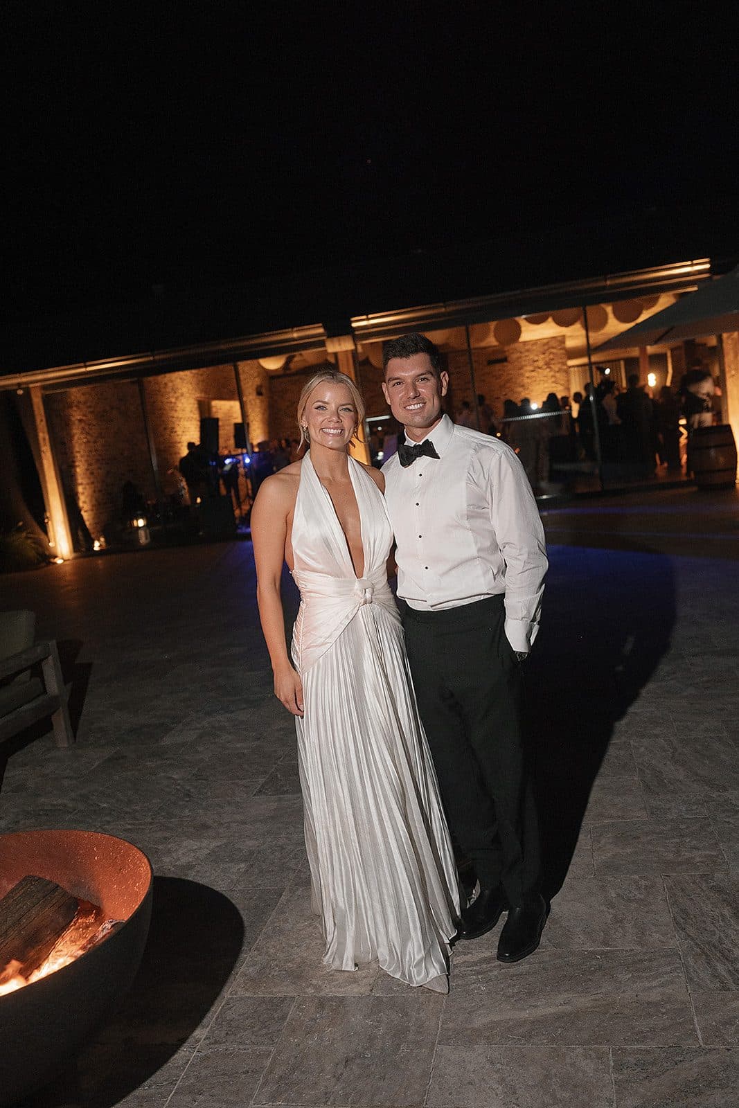 Lauren and Corey outside The Pavilion at night beside the fire bowl