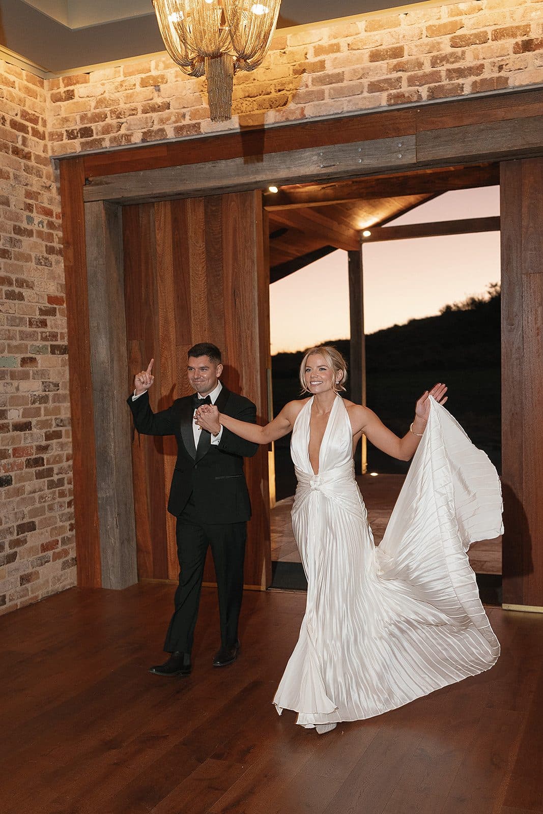Lauren and Corey making their entrance through the timber doors of The Pavilion