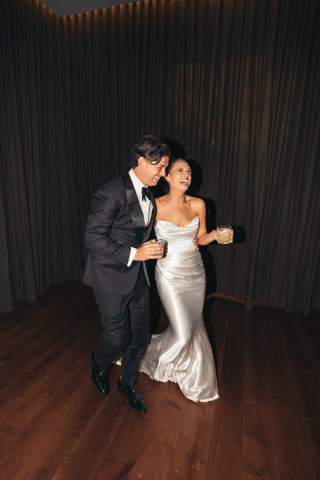 Liv and Ryan dancing in front of the dark curtains after their second entrance