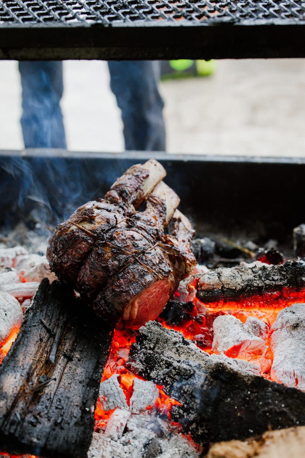 Embers glowing under a steel grill