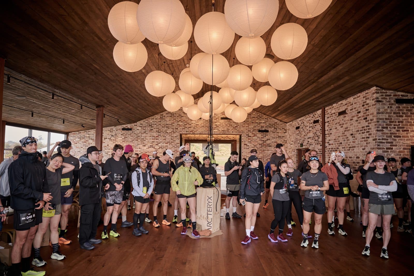 The field gathered inside the Pavilion under the lanterns before the start