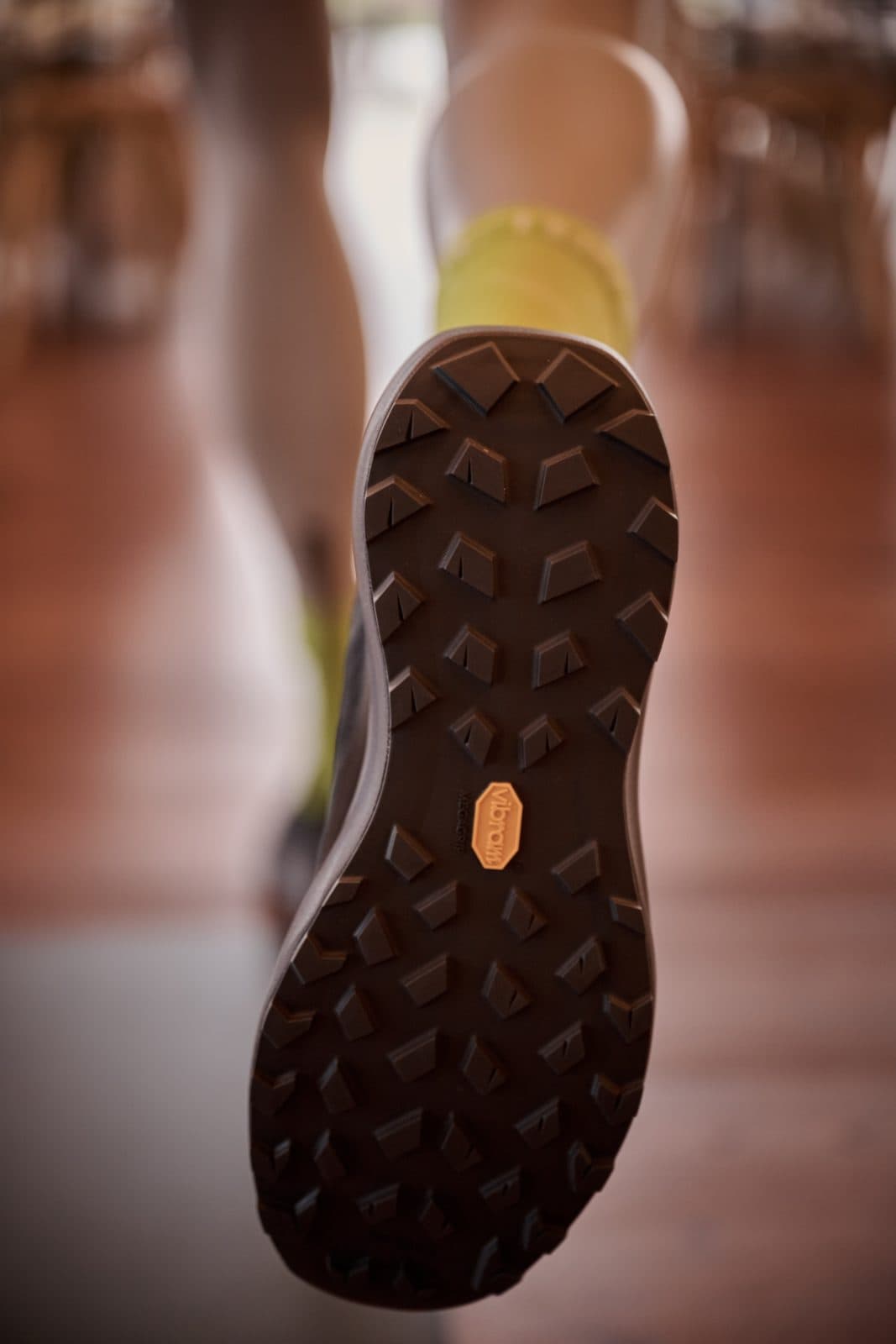 The sole of a Sylan 2 trail shoe, mid-stride on the Pavilion floor