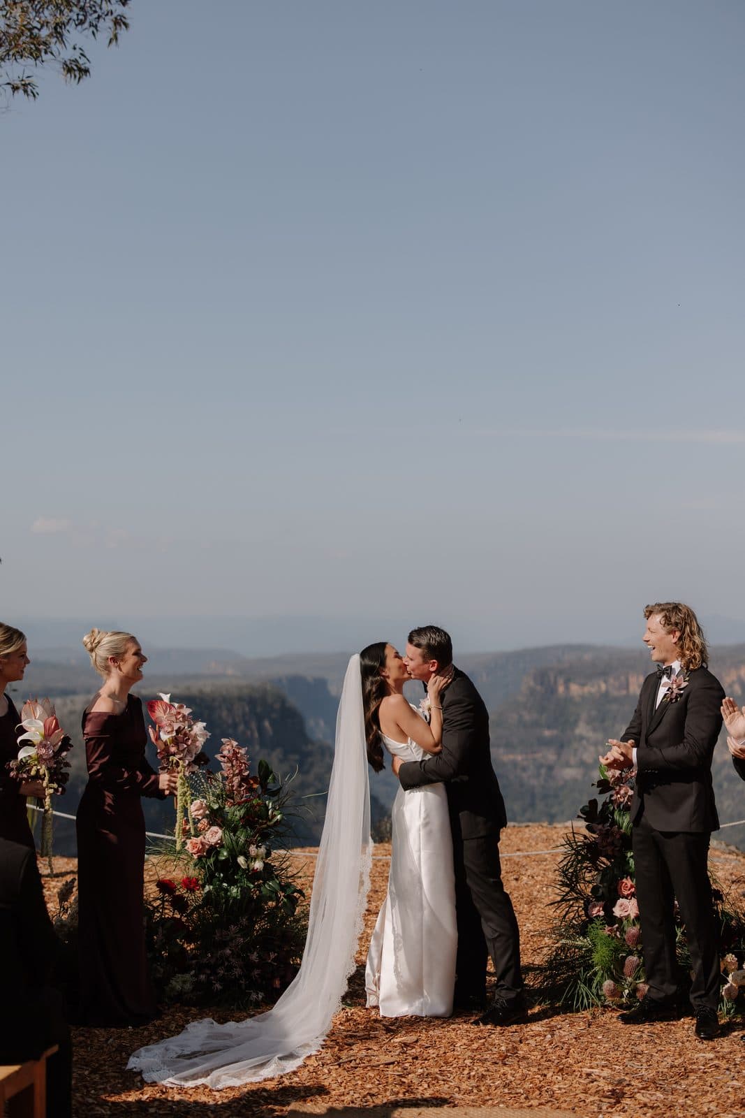 Jamae and Ben's first kiss at the end of the ceremony, the gorge behind them