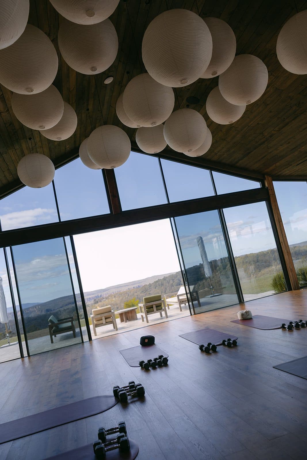 The Pavilion laid out with mats and weights before a session, light across the floorboards