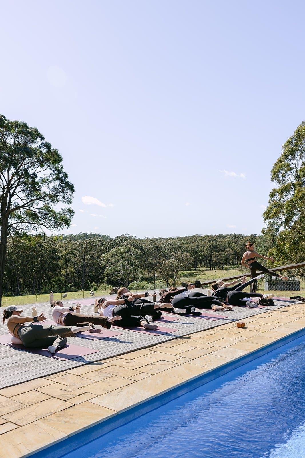 A session on the Homestead pool deck, the pool running the length of the frame
