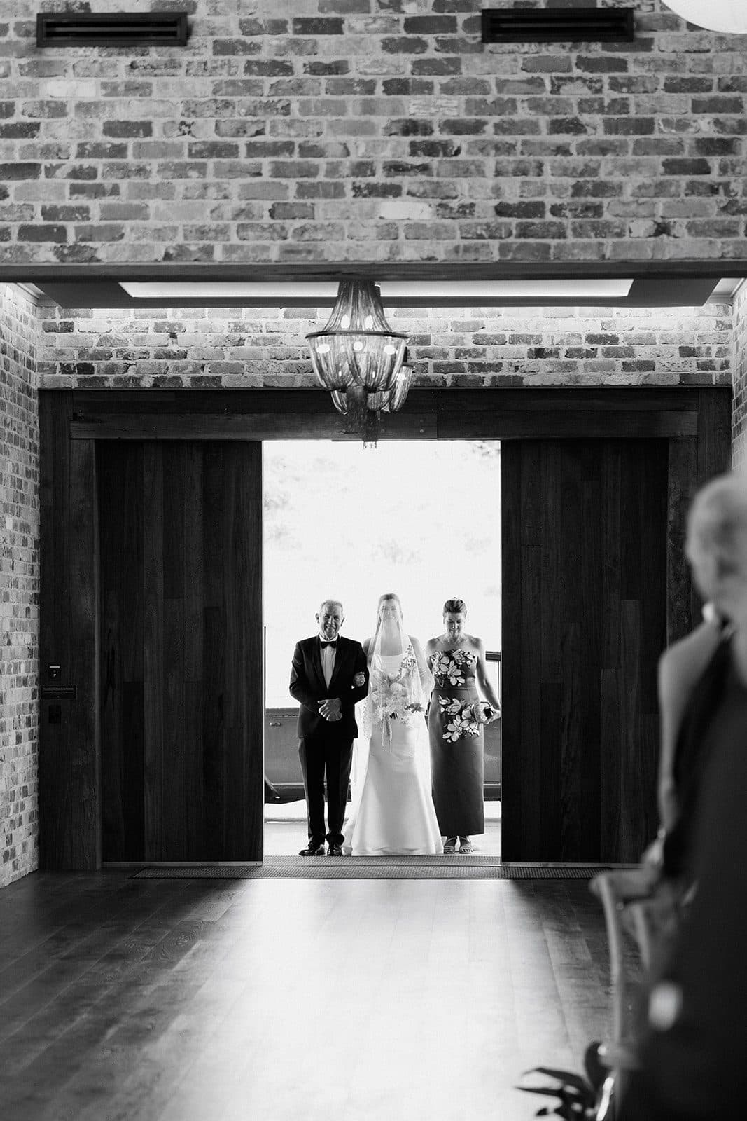 The doors of The Pavilion opening on Holly and her parents, about to walk in