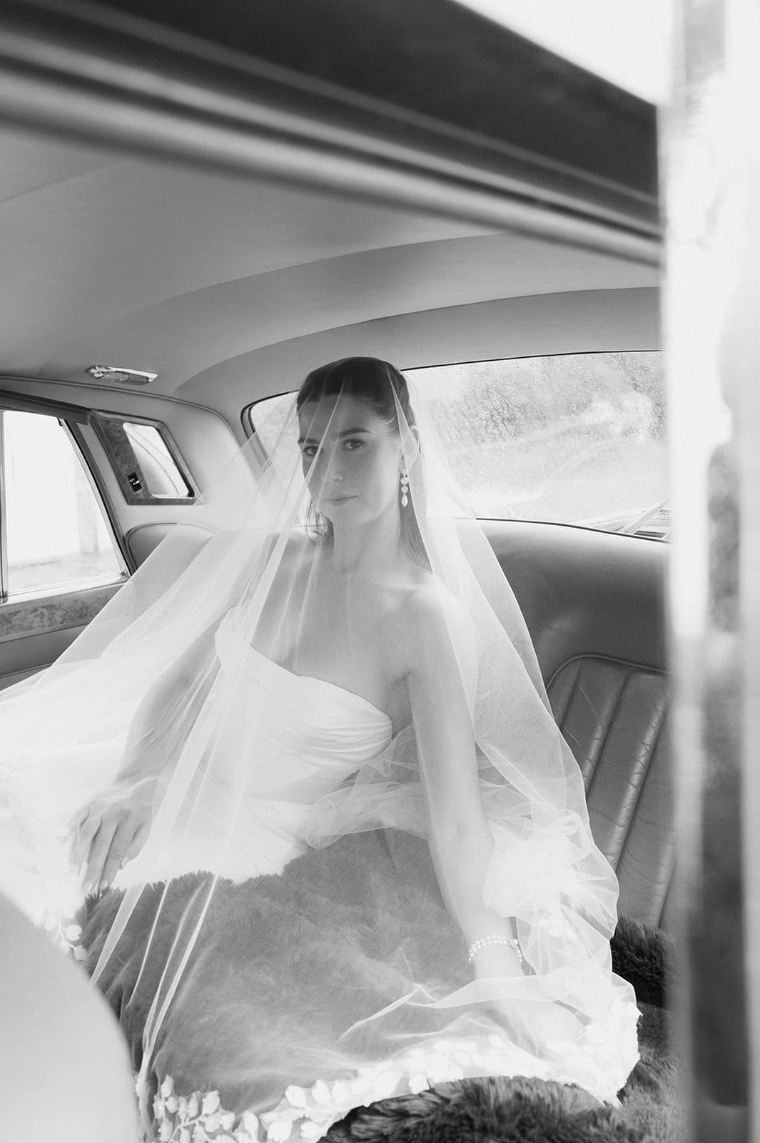 Holly in the back of the 1968 Rolls-Royce on the way down from The Homestead, her veil across the seat beside her