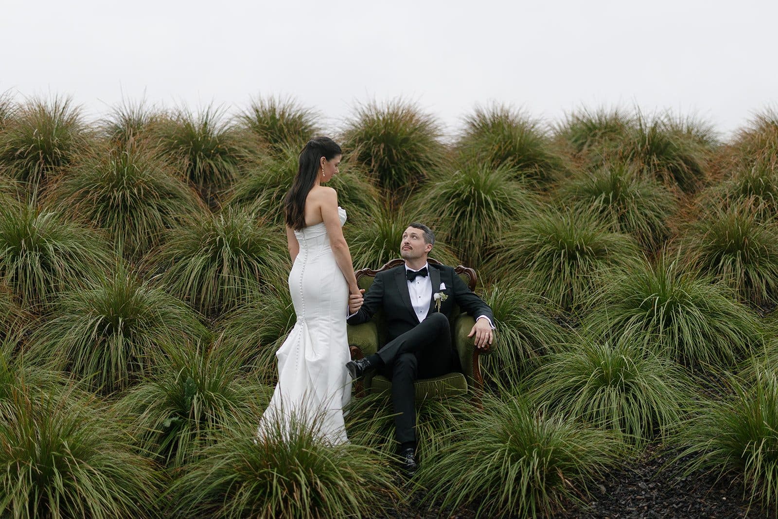 Matt and Holly among the tussock grasses outside the Pavilion, laughing