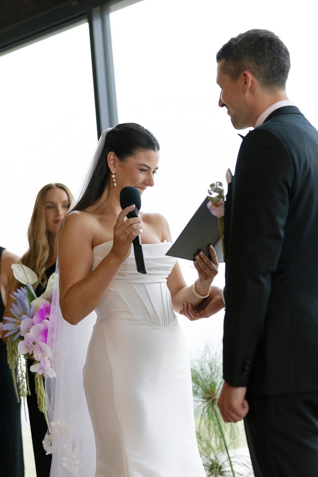 Holly reading her vows to Matt against the glass
