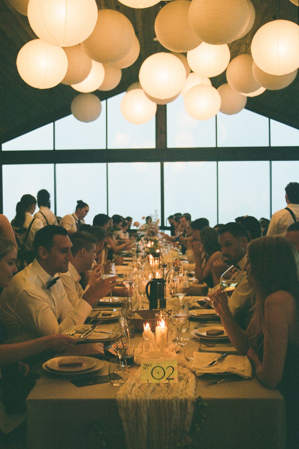 Guests dining under lantern light in the Pavilion at Caoura Cliffs