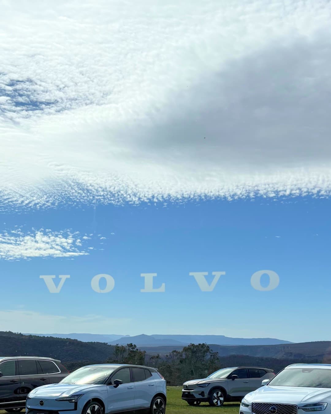 Volvo decal on the Pavilion glass, with launch cars lined up on the lawn below