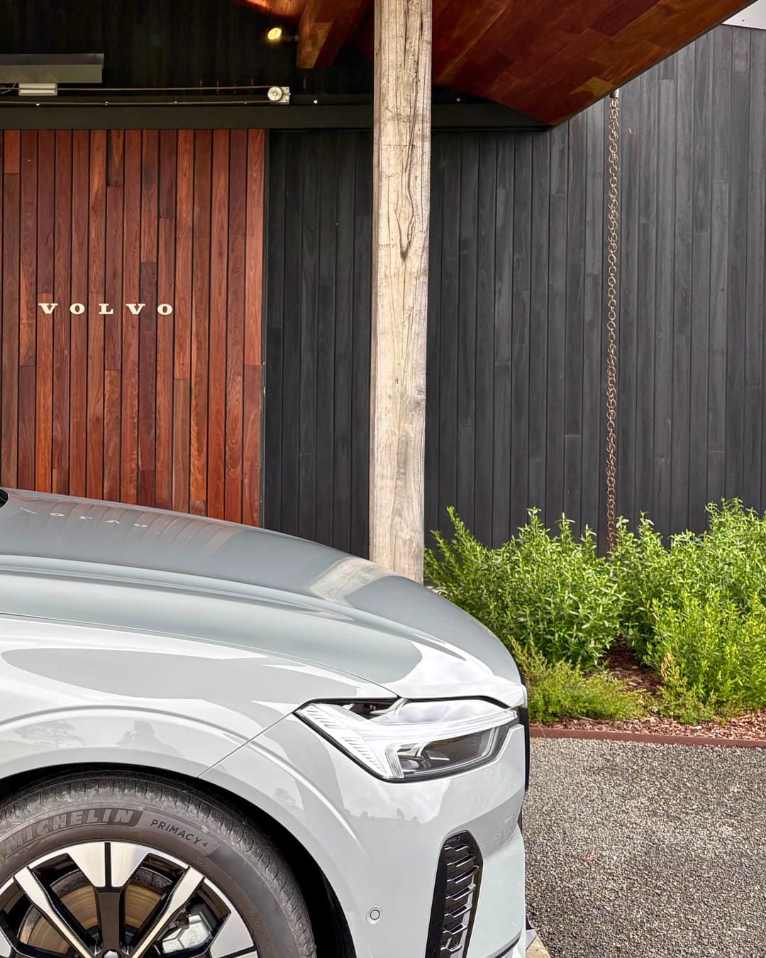 Volvo lettering on the timber entrance of the Pavilion, beside a launch car
